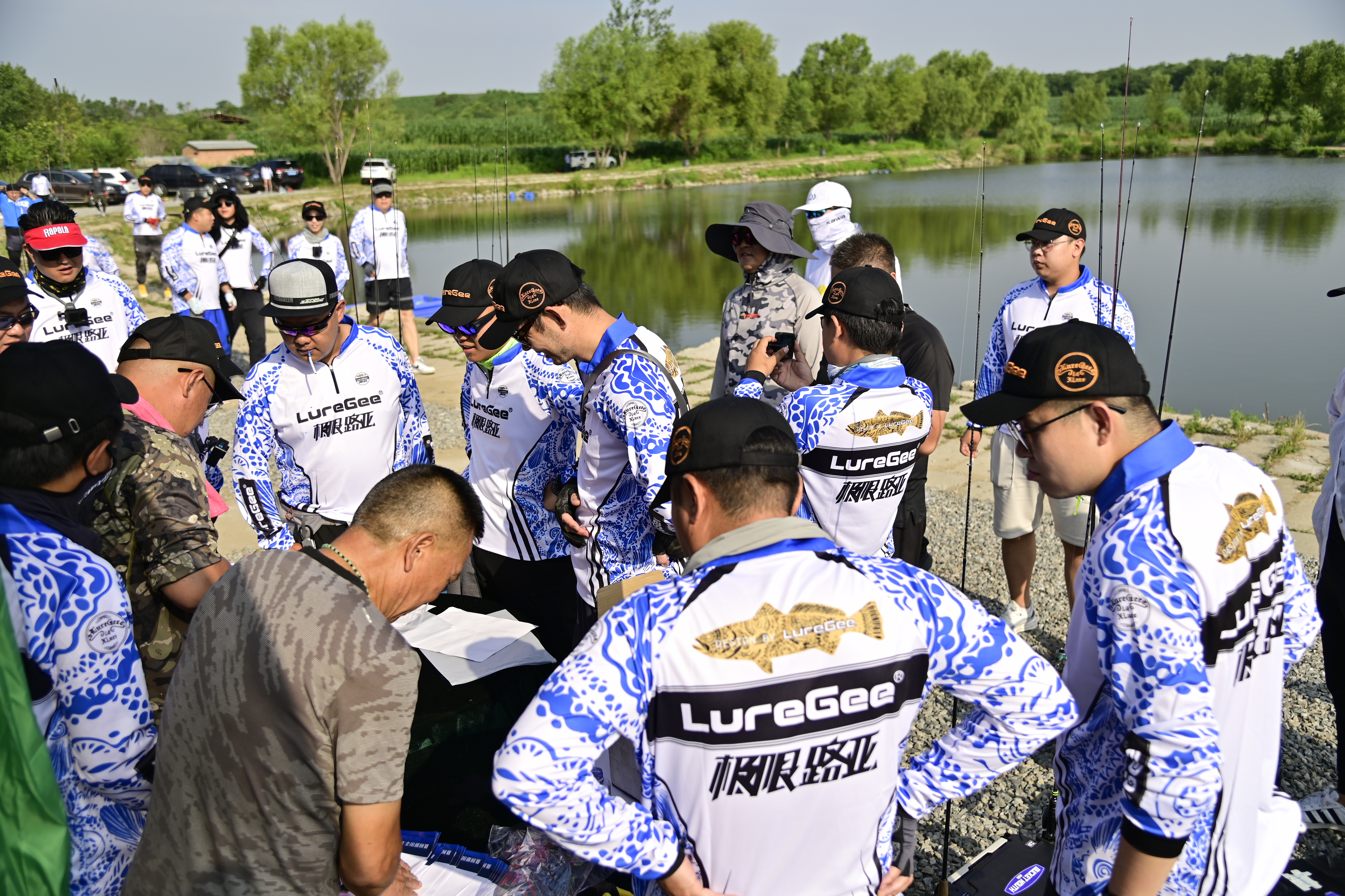 Competitors checking in beside the water before a fishing event