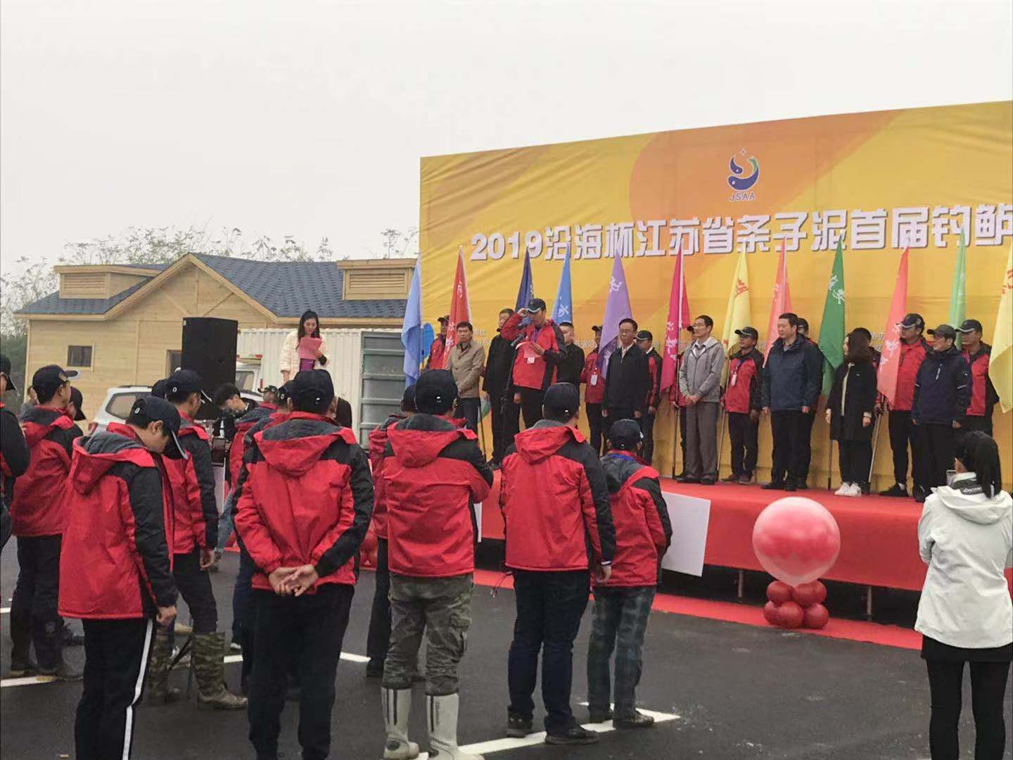 Fishing community watching an outdoor awards ceremony
