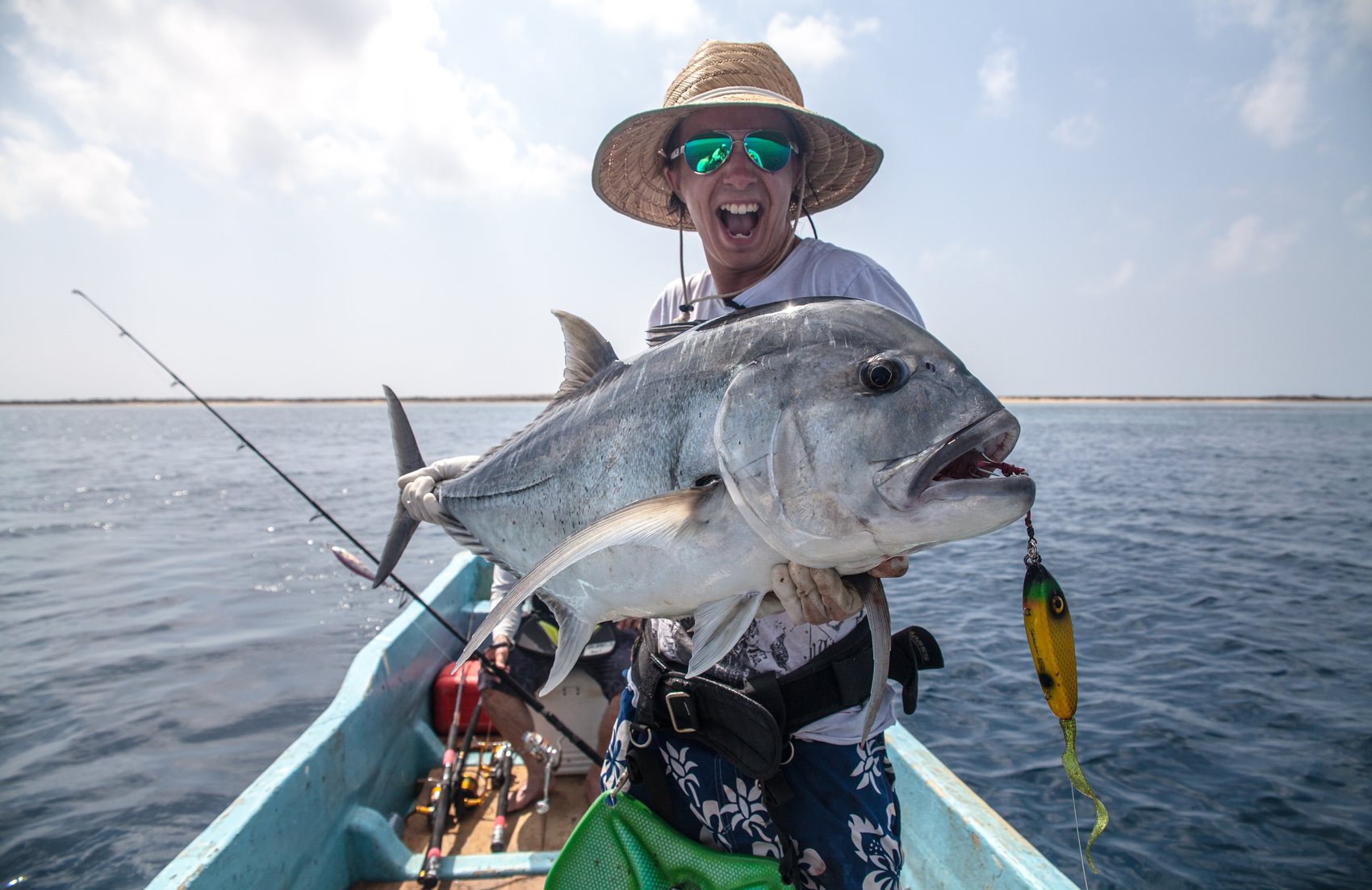 Kayak angler holding a large fish on open water