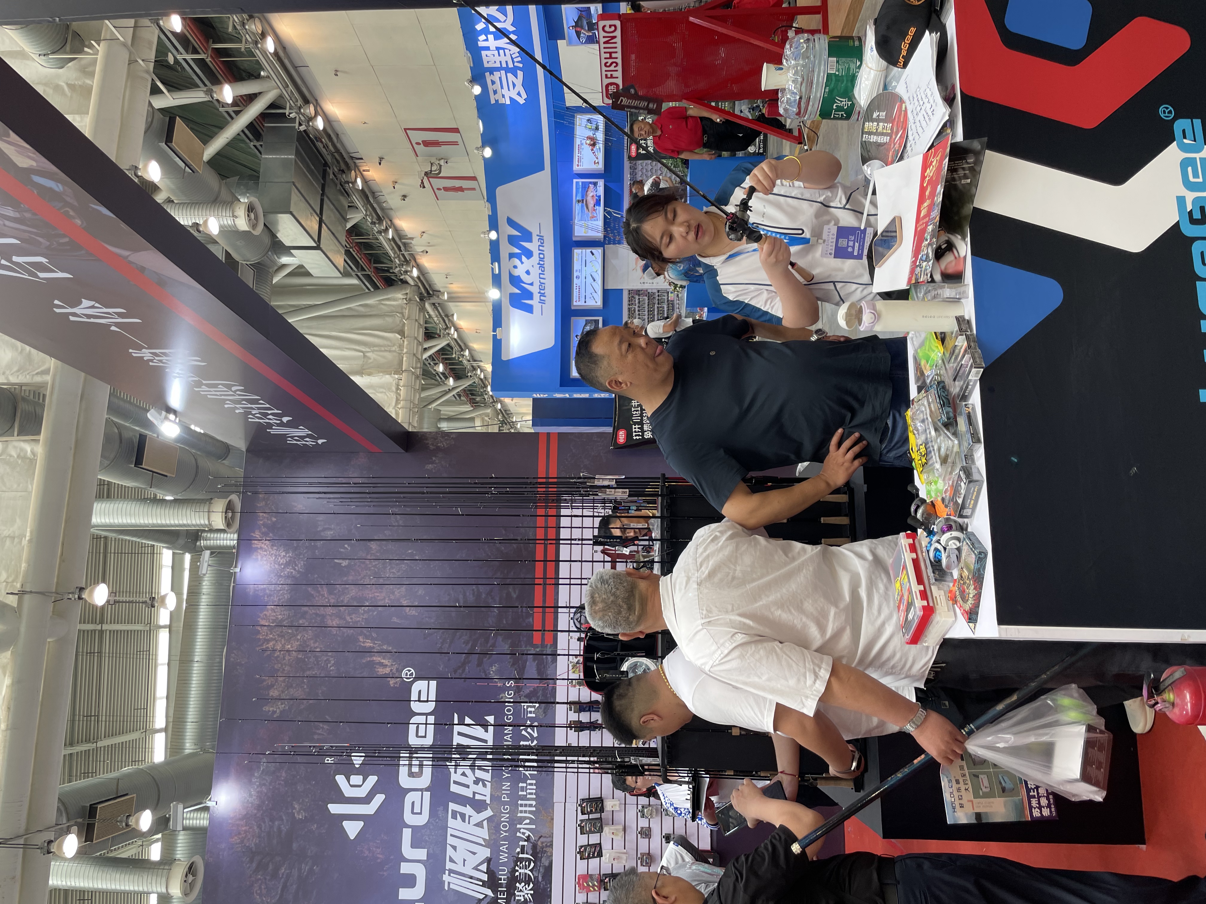International buyers discussing fishing tackle at the LureGee exhibition booth